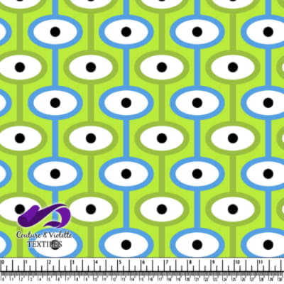 Pattern of blue and white shapes with black dots on green background