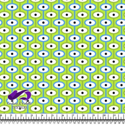 Pattern of blue and white shapes with black dots on green background